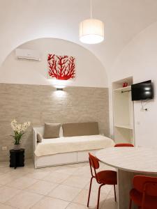 a living room with a couch and a table at Casa Corallium in Torre del Greco