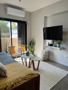 a bedroom with a bed and a flat screen tv at Departamento de Josefina in Santiago del Estero