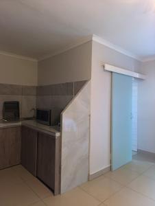 a kitchen with a counter top and a microwave at Siyapeya Household in Bellville +1 photo