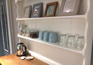 a shelf filled with jars on a wall at Heydon Private Guest Suite Self Check-in & Parking in Heydon