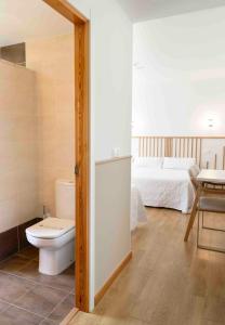 a bathroom with a toilet and a bed at Hotel San Briz in A Pontenova +43 photos