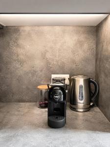 a coffee maker and a tea kettle on a counter at Glūdas Grava in Cēsis