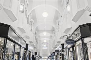 a shopping mall with windows and pendant lights at Best Western ToRVEhallerne in Vejle
