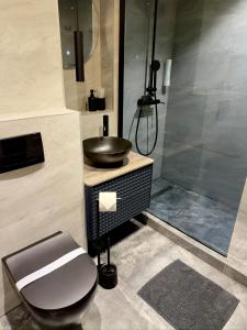 a bathroom with a sink and a toilet and a shower at Apartman KATY - self check-in, besplatan parking, blizu centra in Vukovar +40 photos