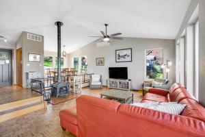 a living room with a red couch and a table at Olympus View Home in Port Ludlow