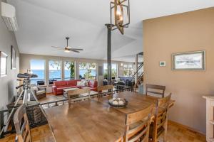 a dining room and living room with a table and chairs at Olympus View Home in Port Ludlow