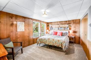 a bedroom with a bed and a book shelf at Olympus View Home in Port Ludlow