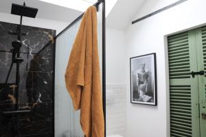 a bathroom with a towel hanging on a wall at M28 - Maison de campagne avec climatisation in Barby +23 photos