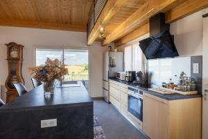 a kitchen with a counter top and a large window at Maison Chalet in Le Nayrac +27 photos