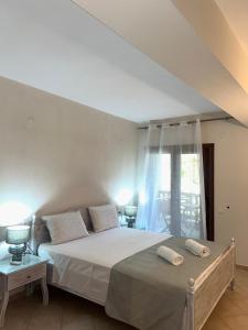 a bedroom with a bed with two towels on it at Sea and Stone Apartment in Afitos