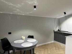 a dining room with a table and chairs in a kitchen at ZWIN Apartment 4 in Skole