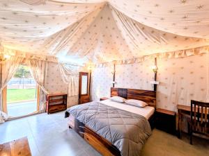 a bedroom with a bed in a tent at Whispering Woods in Gorthan +13 photos