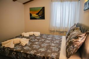 a bedroom with a bed and a window at Villa Angela in Orebić