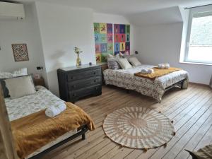 a bedroom with two beds and a table at M28 - Maison de campagne avec climatisation in Barby