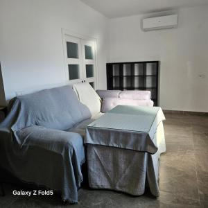 a living room with a couch and a table at Aires de Benatae in Benatae
