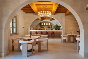 a restaurant with tables and chairs and a bar at Villa Petriolo - Small Luxury Hotels of the World in Cerreto Guidi