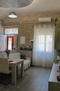 a living room with a couch and a table at CAMARDA SUITE in Bernalda +27 photos