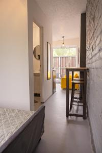 a bedroom with a bed and a table and a chair at Liepaja Garden Studio with Terrace in Liepāja +11 photos
