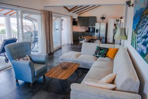 a living room with a couch and two chairs and a table at Villa Angela in Orebić