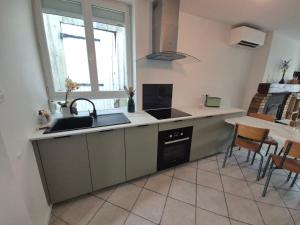 a kitchen with a sink and a stove at M28 - Maison de campagne avec climatisation in Barby