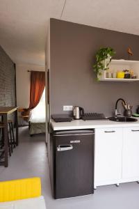 a kitchen with a sink and a stove top oven at Liepaja Garden Studio with Terrace in Liepāja