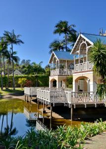 a house on a pier with a reflection in the water at Caribbean Estates by MyResorts in Port Edward