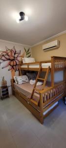 a bedroom with two bunk beds in a room at Casa ao mar -Pousada Itapema in Itapema