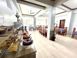 a buffet line with food on a table in a restaurant at Palace Hotel Pôr do Sol in Vitória da Conquista
