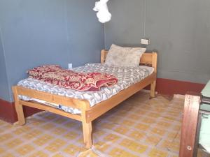 a small bed sitting in a room with at Turacova Safaris & Accommodation in Mara Simba +8 photos