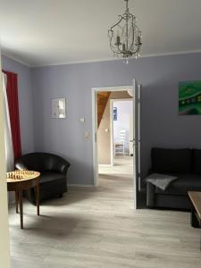 a living room with a couch and a table at Familienhaus Stadtmitte in Neustrelitz