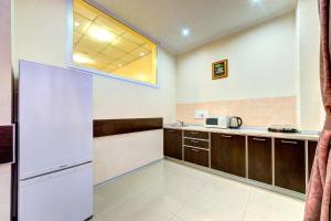 a kitchen with a white refrigerator and a window at Terra Nova Spa Hotel in Hatne +33 photos