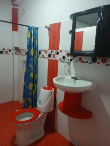 a bathroom with a toilet and a sink at Hotel Pablo's in Tumaco
