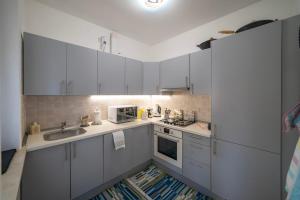 a kitchen with white cabinets and a sink at Interno 8 - Franciacorta x 7 in Passirano