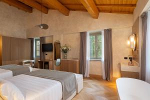 a hotel room with two beds and a window at Villa Petriolo - Small Luxury Hotels of the World in Cerreto Guidi +57 photos