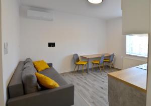 a living room with a couch and a table at Privet Apartman in Balatonfüred