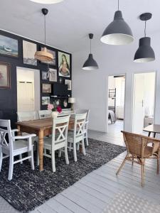 a dining room with a wooden table and chairs at Sowa Loft in Zagórze Śląskie