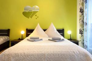 a bedroom with a bed with towels on it at Neptun in Kołobrzeg +66 photos
