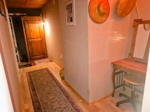 a hallway with a door and a table and a rug at Maison mitoyenne avec terrasse in Asuel