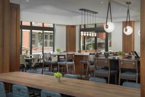 a dining room with tables and chairs and a restaurant at Courtyard by Marriott Richmond Downtown in Richmond
