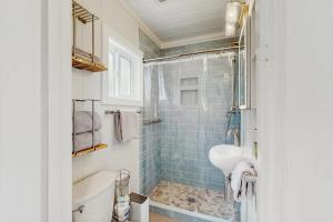 a bathroom with a tub and a sink and a shower at Breezy Point Retreat in Saratoga Shores +26 photos