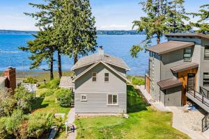 an aerial view of a house next to the water at Breezy Point Retreat in Saratoga Shores