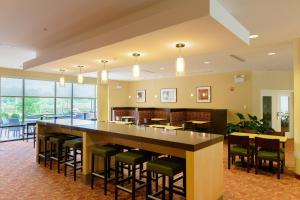 a large bar in a restaurant with chairs and tables at TownePlace Suites by Marriott Frederick in Frederick