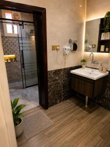 a bathroom with a sink and a shower at ليالي أكنان للشقق المخدومة فرع2 in Abha +21 photos