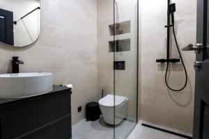 a bathroom with a shower and a toilet and a sink at Villa Truman Klek in Klek +27 photos