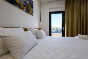 a bedroom with a large white bed with a window at Villa Truman Klek in Klek
