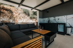 a living room with a couch and a table at Villa Truman Klek in Klek