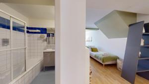 a bathroom with a bed and a sink in a room at COLMARAPPART Grand'Rue in Colmar +222 photos