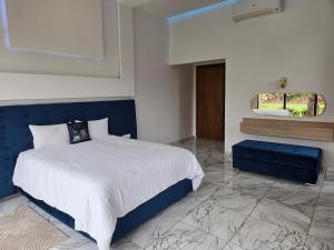 a bedroom with a blue and white bed and a mirror at Villa Serenity MARRAKECH in Oulad Mazoug +47 photos
