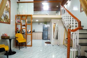 a kitchen with a staircase and a kitchen with a refrigerator at Dốc Phố Home - Dalat Homestay in Xuan An