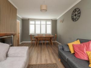 a living room with a couch and a table at Shepherd's Lodge in Skipton
